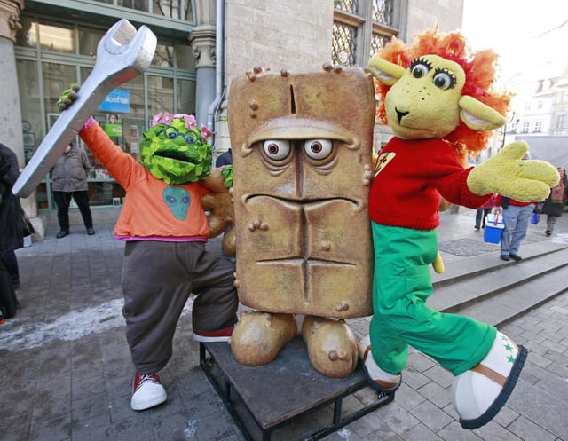 FILE - The puppet characters on the German children's television channel 'Kika' 'Briegel der Busch', left, and 'Chilie das Schaf', right, present the statue "Bernd das Brot" at his regular place in front of the City hall in Erfurt, Germany, Wednesday, Feb. 4, 2009. (AP Photo/Jens Meyer, File)