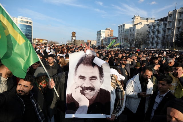 A demonstrator holds a picture of jailed Kurdish militant leader Abdullah Ocalan during a rally in Diyarbakir, Turkey, February 27, 2025. REUTERS/Sertac Kayar/File Photo