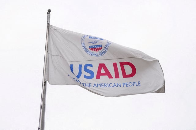 A USAID flag flutters outside, as the USAID building sits closed to employees after a memo was issued advising agency personnel to work remotely, in Washington, D.C., U.S., February 3, 2025. REUTERS/Kent Nishimura//File Photo
