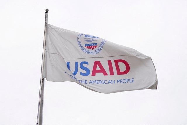 A USAID flag flutters outside, as the USAID building sits closed to employees after a memo was issued advising agency personnel to work remotely, in Washington, D.C., U.S., February 3, 2025. REUTERS/Kent Nishimura/File Photo