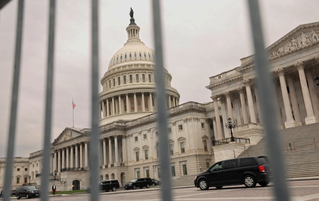 The dome of the Capitol is seen through a security fence on a day where a potential government shutdown looms during the holidays after a spending bill backed by Donald Trump failed in the U.S. House of Representatives, on Capitol Hill in Washington, U.S., December 20, 2024. REUTERS/Kevin Lamarque/File Photo