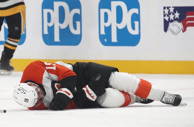 Feb 27, 2025; Pittsburgh, Pennsylvania, USA;  Philadelphia Flyers right wing Garnet Hathaway (19) lays on the ice after suffering an apparent injury after being hit by Pittsburgh Penguins left wing Bokondji Imama (not pictured) during the second period at PPG Paints Arena. Mandatory Credit: Charles LeClaire-Imagn Images