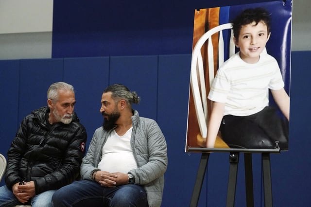 FILE - Wadee Alfayoumi's father, Oday Al Fayoume, seated right, and his uncle Mahmoud Yousef attend a vigil for Wadee at Prairie Activity and Recreation center in Plainfield, Ill., Oct. 17, 2023. (AP Photo/Nam Y. Huh, File)