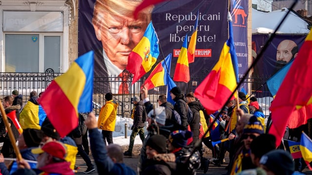 Supporters of Calin Georgescu, a presidential candidate in Romania, as he is quizzed by police over alleged war crimes and campaign funds