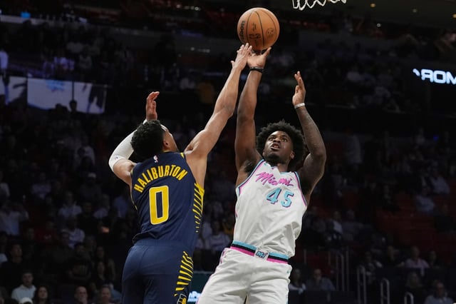 Miami Heat guard Davion Mitchell (45) aims to score as Indiana Pacers guard Tyrese Haliburton (0) defends during the first half of an NBA basketball game, Friday, Feb. 28, 2025, in Miami. (AP Photo/Marta Lavandier)