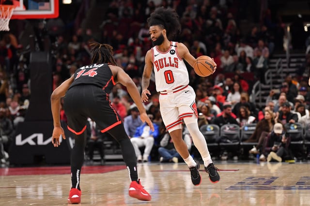 Feb 28, 2025; Chicago, Illinois, USA; Chicago Bulls guard Coby White (0) controls the ball against Toronto Raptors guard Ja'Kobe Walter (14) during the second half at the United Center. Mandatory Credit: Patrick Gorski-Imagn Images