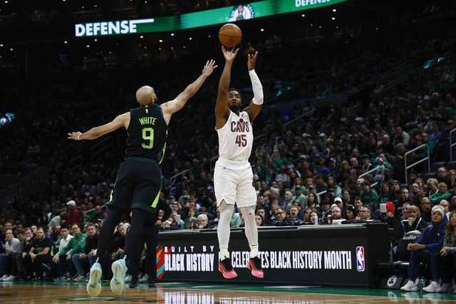 Feb 28, 2025; Boston, Massachusetts, USA; Cleveland Cavaliers guard Donovan Mitchell (45) shoots over Boston Celtics guard Derrick White (9) during the second half at TD Garden. Mandatory Credit: Winslow Townson-Imagn Images