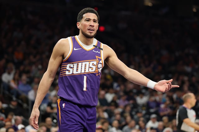 PHOENIX, ARIZONA - FEBRUARY 27: Devin Booker #1 of the Phoenix Suns reacts during the first half of the NBA game against the New Orleans Pelicans at PHX Arena on February 27, 2025 in Phoenix, Arizona.