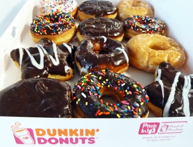 An assortment of Dunkin&#39; Donuts ring doughnuts and filled doughnuts, glazed doughnuts and powdered doughnuts is seen in a paper box in Washington, DC June 5, 2015.