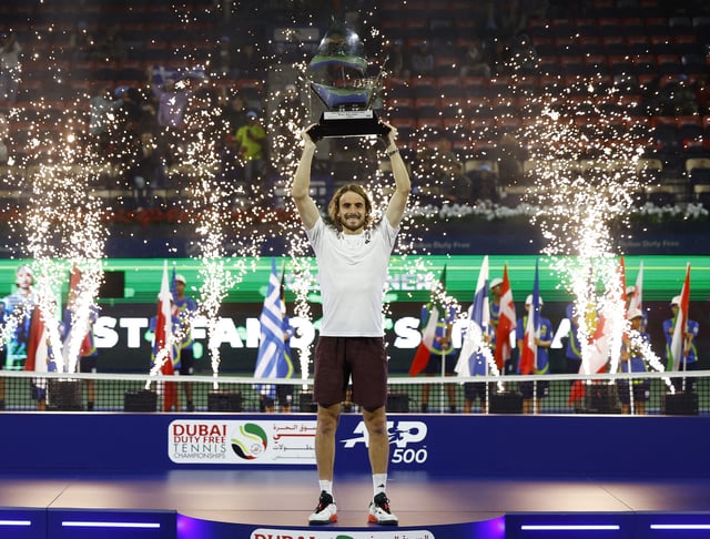 Tennis - Dubai Championships - Dubai Tennis Stadium, Dubai, United Arab Emirates - March 1, 2025 Greece's Stefanos Tsitsipas celebrates with trophy after winning his final match against Canada's Felix Auger Aliassime REUTERS/Rula Rouhana