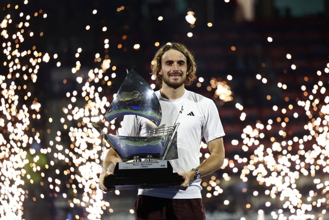 Tennis - Dubai Championships - Dubai Tennis Stadium, Dubai, United Arab Emirates - March 1, 2025 Greece's Stefanos Tsitsipas celebrates with trophy after winning his final match against Canada's Felix Auger Aliassime REUTERS/Amr Alfiky
