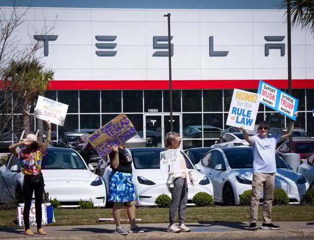 About 150 people representing Indivisible Mandarin, Beaches Activists Movement, Indivisible St. Johns County and other groups, gathered for a rally Wednesday February 26, 2025 in front of the Tesla dealership on Atlantic Blvd and Abess Blvd. in Jacksonville, Fla. They were protesting the access that Elon Musk has on American’s personal data which they feel is a threat to our privacy. [Doug Engle/Florida Times-Union]2025