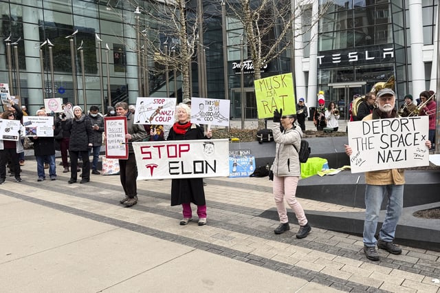 Protesters rally outside of a Tesla store in Boston, Saturday, March 1, 2025, against the company's CEO, Elon Musk, who is leading an effort to cut government jobs on behalf of President Donald Trump. (AP Photo/Rodrique Ngowi)