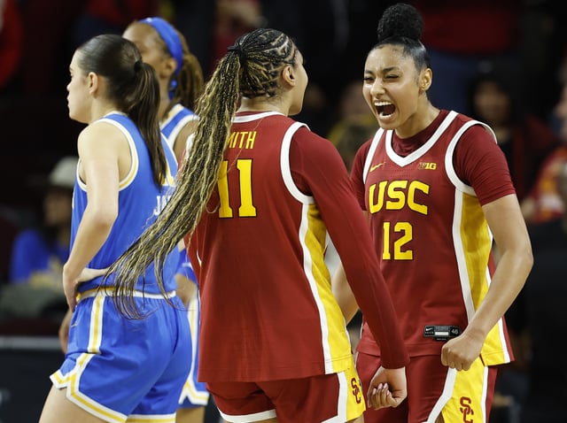 Kennedy Smith #11 and JuJu Watkins #12 of the USC Trojans react against the UCLA Bruins in the second half at Galen Center on February 13, 2025 in Los Angeles, California.