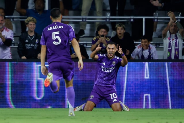 Orlando City midfielder Martín Ojeda (10) reacts after his goal as midfielder César Araújo (5) runs to congratulate him as they play Toronto FC during the second half of an MLS soccer match, Saturday, March 1, 2025, in Orlando, Fla. (AP Photo/Kevin Kolczynski)