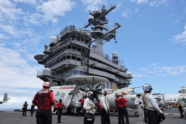Flight deck crew members watch jets take off from the USS Carl Vinson aircraft carrier during the Rim of the Pacific (RIMPAC) military exercises about 100 miles south of Oahu, Hawaii, U.S. July 19, 2024.  REUTERS/Marco Garcia/File Photo
