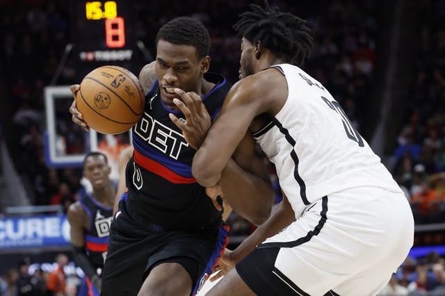 Mar 1, 2025; Detroit, Michigan, USA;  Detroit Pistons center Jalen Duren (0) is defended by Brooklyn Nets center Day'Ron Sharpe (20) in the second half at Little Caesars Arena. Mandatory Credit: Rick Osentoski-Imagn Images