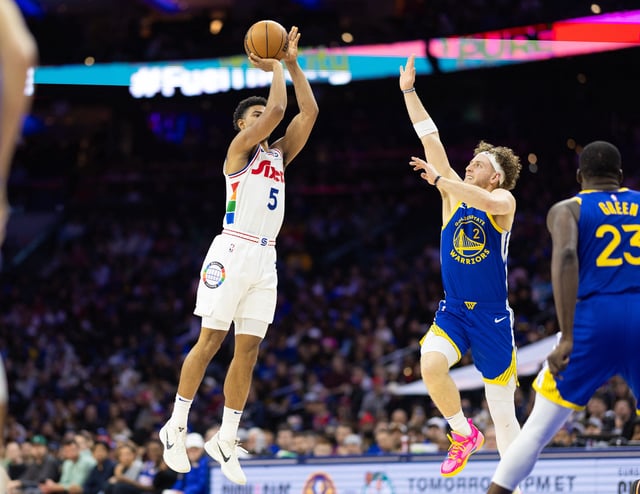 Mar 1, 2025; Philadelphia, Pennsylvania, USA; Philadelphia 76ers guard Quentin Grimes (5) shoots past Golden State Warriors guard Brandin Podziemski (2) during the second quarter at Wells Fargo Center. Mandatory Credit: Bill Streicher-Imagn Images