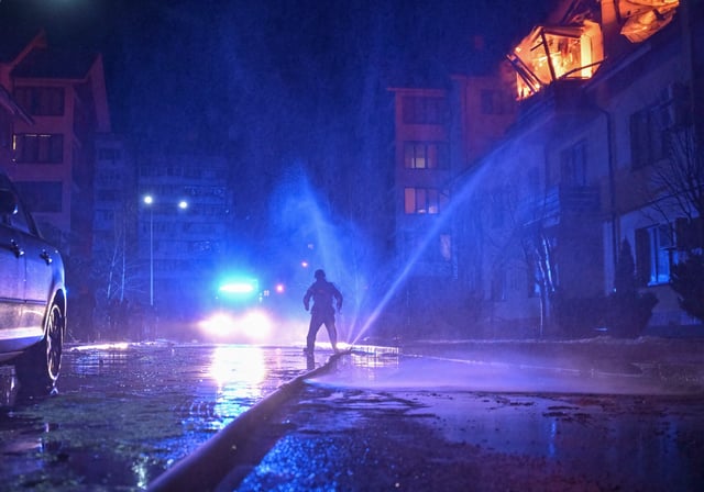 A firefighter works at a site of an apartment building hit by a Russian drone strike, amid Russia's attack on Ukraine, in Zaporizhzhia, Ukraine March 1, 2025. REUTERS/Stringer