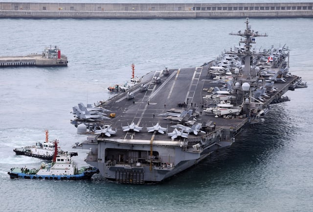 The USS Carl Vinson aircraft carrier is escorted into a navy port in Busan, South Korea, Sunday, March 2, 2025.