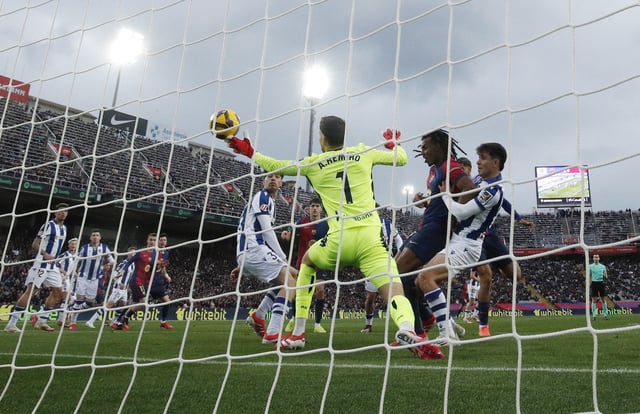 Soccer Football - LaLiga - FC Barcelona v Real Sociedad - Estadi Olimpic Lluis Companys, Barcelona, Spain - March 2, 2025 FC Barcelona's Ronald Araujo scores their third goal past Real Sociedad's Alex Remiro REUTERS/Albert Gea
