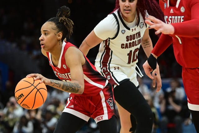 Apr 5, 2024; Cleveland, OH, USA; NC State Wolfpack guard Aziaha James (10) dribbles the ball past South Carolina Gamecocks center Kamilla Cardoso (10) in the semifinals of the Final Four of the womens 2024 NCAA Tournament at Rocket Mortgage FieldHouse. Ken Blaze-USA TODAY Sports/File Photo