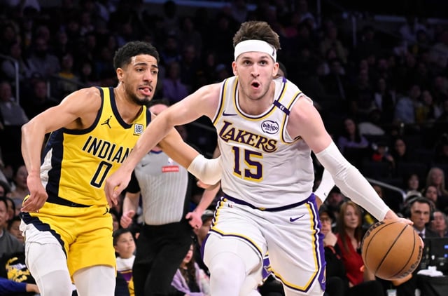 Austin Reaves #15 of the Los Angeles Lakers drivers to the basket past Tyrese Haliburton #0 of the Indiana Pacers in the second half of a NBA basketball game at Crypto.com Arena in Los Angeles on Saturday, Feb. 8, 2025.  (Photo by Keith Birmingham, Orange County Register/ SCNG)