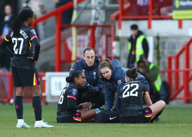 Soccer Football - Women's Super League - Brighton & Hove Albion v Chelsea - Broadfield Stadium, Crawley, Britain - March 2, 2025 Chelsea's Naomi Girma receives medical attention after sustaining an injury as Chelsea's Lucy Bronze looks on Action Images via Reuters/Matthew Childs