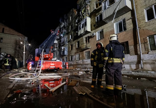 Firefighters work at a site of an apartment building hit by a Russian drone strike, amid Russia's attack on Ukraine, in Kharkiv, Ukraine March 2, 2025. REUTERS/Sofiia Gatilova