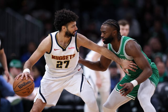 Mar 2, 2025; Boston, Massachusetts, USA; Denver Nuggets guard Jamal Murray (27) defended by Boston Celtics forward Jaylen Brown (7) during the second half at TD Garden. Mandatory Credit: Paul Rutherford-Imagn Images