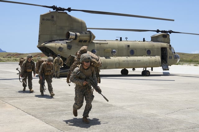 FILE - U.S. troopers alight from a US Army CH-47 carrying American and Philippine troops as it lands at the Philippines' northernmost town of Itbayat, Batanes province during a joint military exercise on Monday, May 6, 2024. (AP Photo/Aaron Favila, File)
