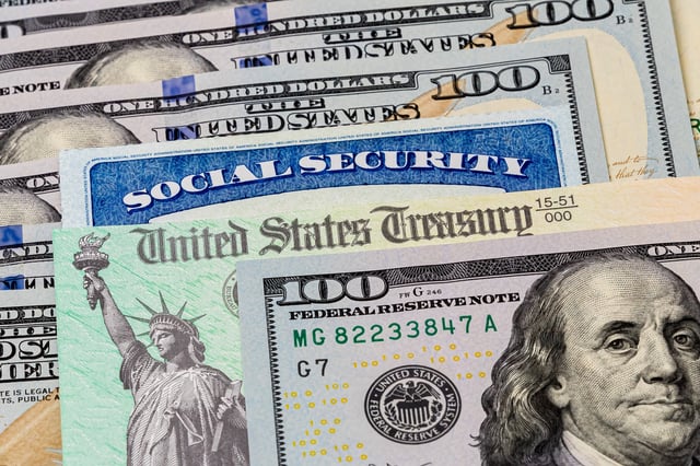 Stock image/file photo: A Social Security card and U.S. Treasury check with U.S. Dollars.