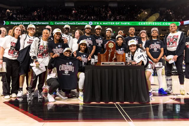Mar 2, 2025; Columbia, South Carolina, USA; South Carolina Gamecocks players pose with the 2024-2025 SEC Regular Season Championship Trophy after defeating the Kentucky Wildcats at Colonial Life Arena. Mandatory Credit: Jeff Blake-Imagn Images
