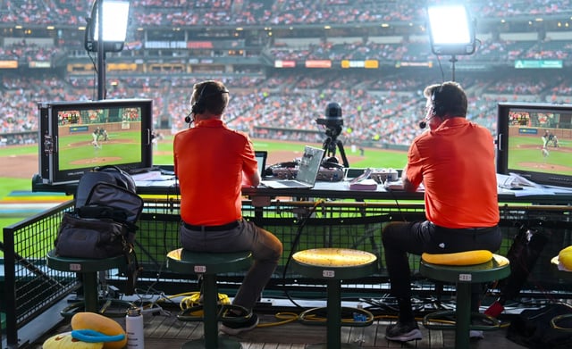 Major League Baseball has frustrated fans by moving some games to streaming platforms instead of showing them on MASN. Orioles broadcast team of Kevin Brown, left, and Jim Palmer covers the game from the center field roof deck. June 28, 2023. (Kevin Richardson/Baltimore Sun)