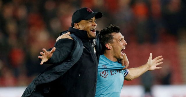 Soccer Football - Championship - Middlesbrough v Burnley - Riverside Stadium, Middlesbrough, Britain - April 7, 2023 Burnley manager Vincent Kompany celebrates promotion to the Premier League with Jack Cork Action Images via Reuters/Craig Brough  