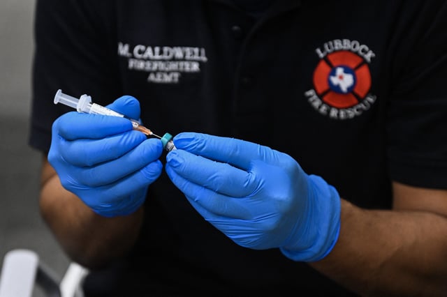 A paramedic prepares a dose of the measles vaccine in Lubbock, Texas on February 27, 2025 amid an outbreak of the virus.