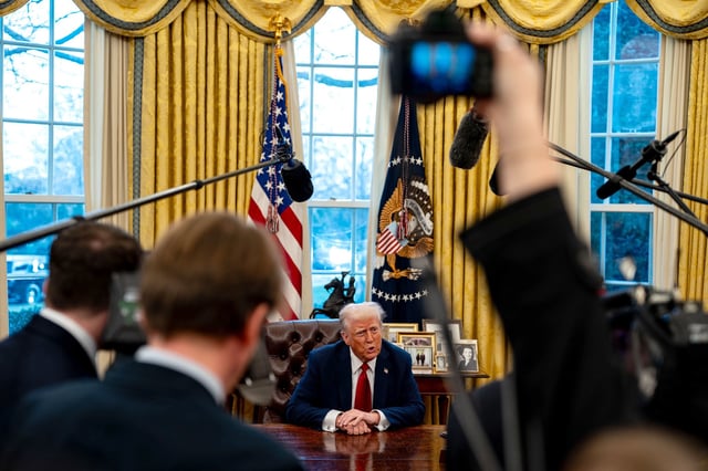 President Donald Trump speaks to members of the press after signing two executive orders in the Oval Office of the White House on January 30 in Washington, DC.