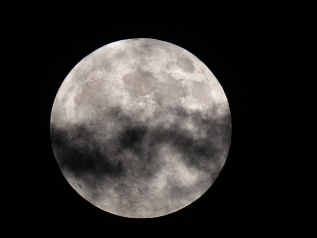 A cloud passes in front of a full moon on Tuesday, Sept. 17, 2024 in Houston. NASA scientists are still studying the potential impact of asteroid 2024 YR4 on the moon after an Earth impact was ruled out. 
