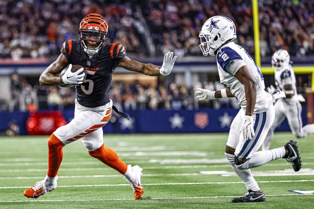 Cincinnati Bengals wide receiver Tee Higgins (5) stiff arms Dallas Cowboys cornerback Jourdan Lewis (2) during the game between the Dallas Cowboys and the Cincinnati Bengals on Dec. 9, 2024 in Arlington, Texas.