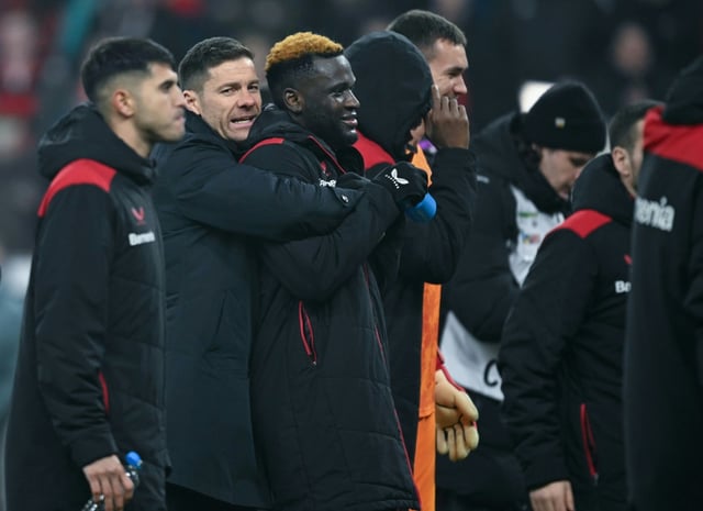 Bayer Leverkusen coach Xabi Alonso embraces striker Victor Boniface