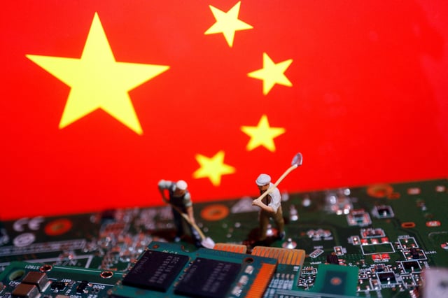 Worker miniatures are placed among the flag of China and printed circuit boards with semiconductor chips, in this illustration picture taken July 5, 2023. REUTERS/Florence Lo/Illustration/File Photo
