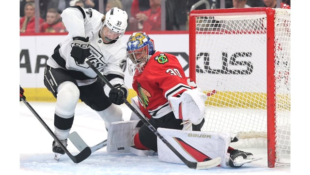 Chicago Blackhawks goaltender Spencer Knight, right, makes a save against the Kings’ Warren Foegele during the first period on Monday night in Chicago. Making his first start for his new team, Knight stopped 41 shots to hand the Kings a 5-1 loss. (Photo by Michael Reaves/Getty Images)