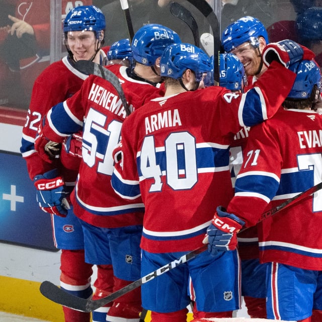 Montreal Canadiens' Mike Matheson (facing) celebrates his winning goal over the Buffalo Sabres with teammates following NHL overtime hockey action in Montreal on Monday, March 3, 2025. THE CANADIAN PRESS/Christinne Muschi