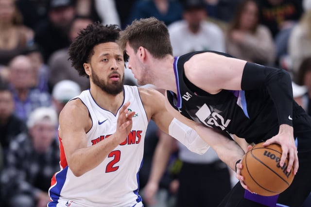 Mar 3, 2025; Salt Lake City, Utah, USA; Utah Jazz forward Kyle Filipowski (22) looks for a play against Detroit Pistons guard Cade Cunningham (2) during the first half at Delta Center. Mandatory Credit: Rob Gray-Imagn Images