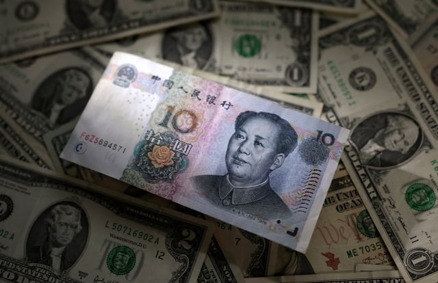Chinese Yuan and U.S. dollar banknotes are seen in this illustration taken March 10, 2023. REUTERS/Dado Ruvic/Illustration/File Photo