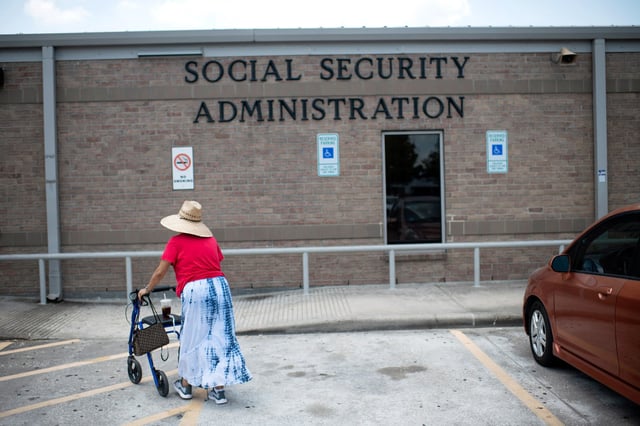 A woman walks into a Social Security office in Houston, on July 13, 2022.
