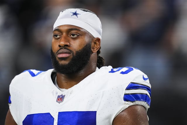 ARLINGTON, TX - DECEMBER 22: Osa Odighizuwa #97 of the Dallas Cowboys looks on from the sideline during the national anthem prior to an NFL football game against the Tampa Bay Buccaneers at AT&amp;T Stadium on December 22, 2024 in Arlington, Texas