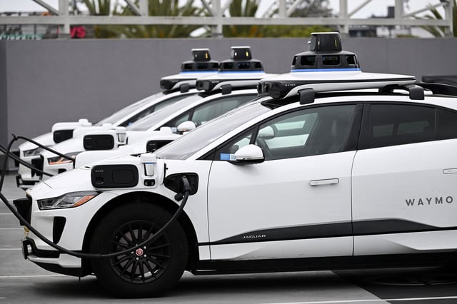 A Waymo autonomous self-driving Jaguar electric vehicle sits parked at an EVgo charging station in Los Angeles, California, on May 15, 2024. The top US auto safety regulator on Tuesday said it had opened an investigation into Google-owned Waymo after reports of 22 incidents with its self-driving technology. The National Highway Traffic Safety Administration's (NHTSA) Office of Defects Investigation said the problems took place in vehicles equipped with Waymo's fifth generation automated driving system. (Photo by Patrick T. Fallon / AFP) (Photo by PATRICK T. FALLON/AFP via Getty Images)