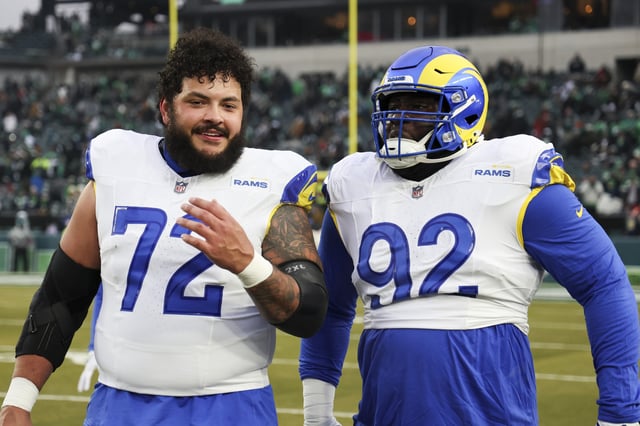 PHILADELPHIA, PENNSYLVANIA - JANUARY 19: Jonah Jackson #72 and Neville Gallimore #92 of the Los Angeles Rams walk together prior to the NFC Divisional playoff game against the Philadelphia Eagles at Lincoln Financial Field on January 19, 2025 in Philadelphia, Pennsylvania.