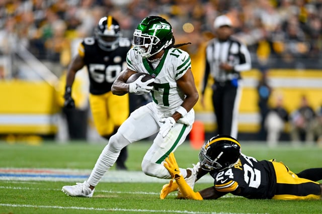 PITTSBURGH, PENNSYLVANIA - OCTOBER 20: Davante Adams #17 of the New York Jets is tackled by Joey Porter Jr. #24 of the Pittsburgh Steelers during the first quarter at Acrisure Stadium on October 20, 2024 in Pittsburgh, Pennsylvania.